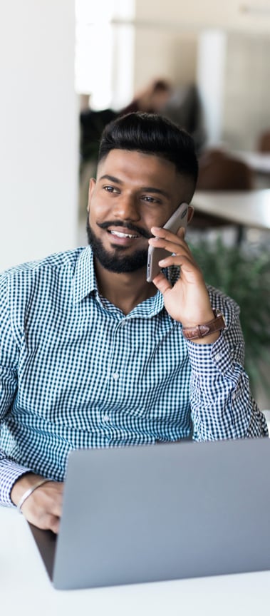 man with moustache on phone