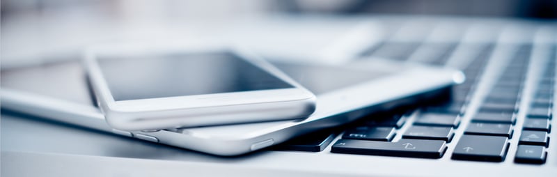 Phone and tablet on top of a laptop