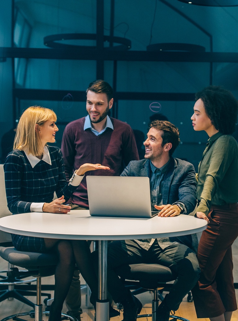 colleagues conversing around a table
