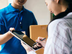 Woman signing for a package